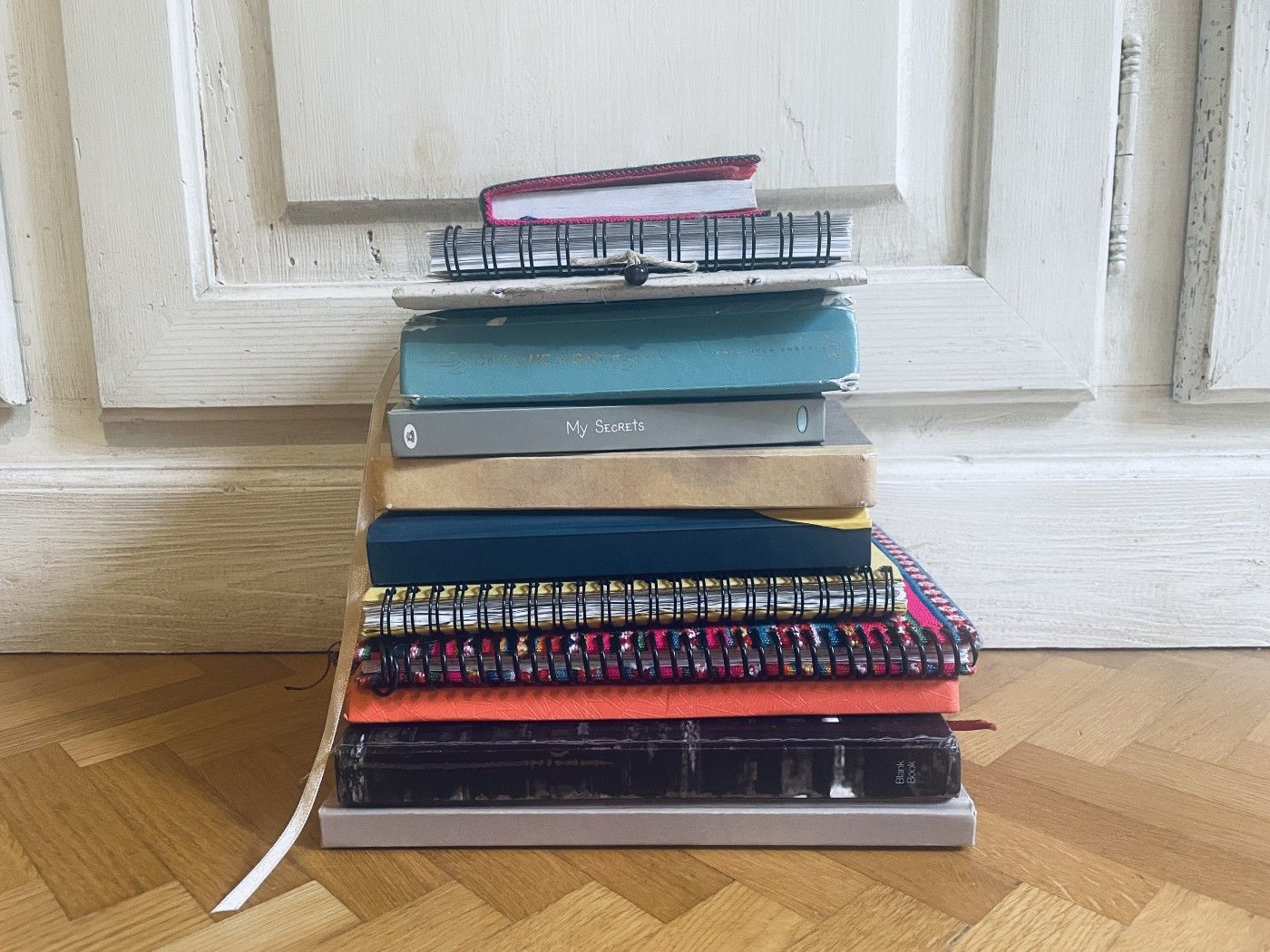 A pile of old diaries and notebooks